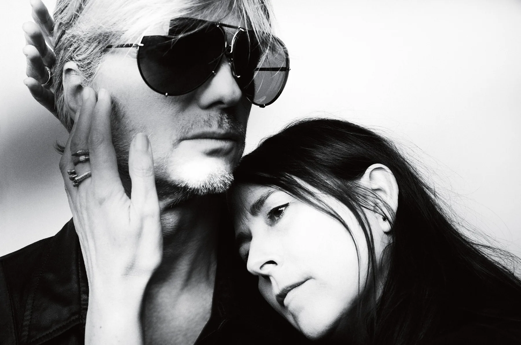 An Vandevorst and Filip Arickx, black-and-white portrait: he in large sunglasses, she resting her head against his