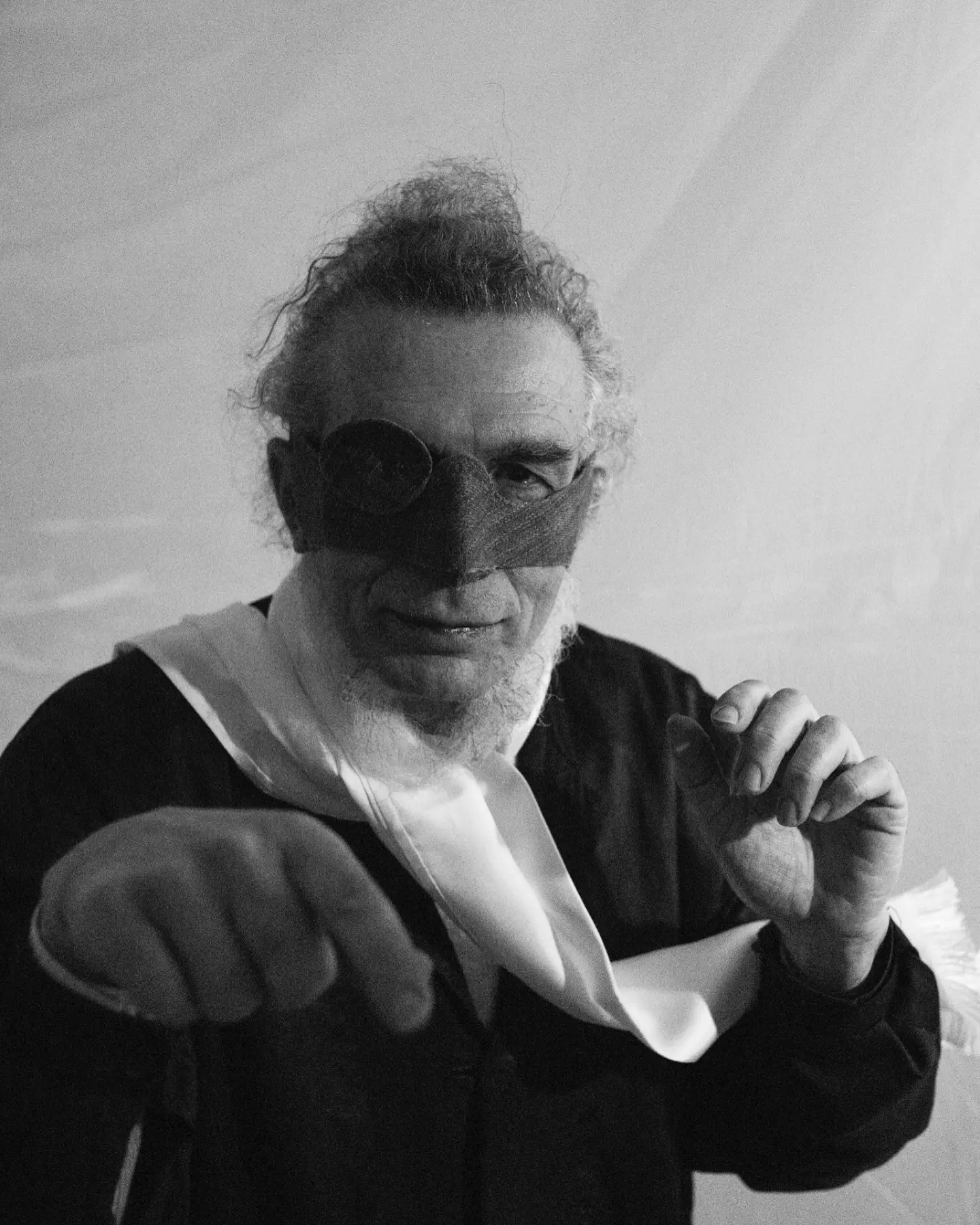 Maurizio Altieri, black-and-white portrait with a leather mask over his eyes