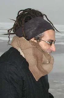 Maurizio Altieri with dreadlocks, a headband and a knitted scarf