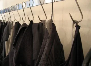 Carpe Diem garments hanging on meat hooks at Atelier boutique, New York