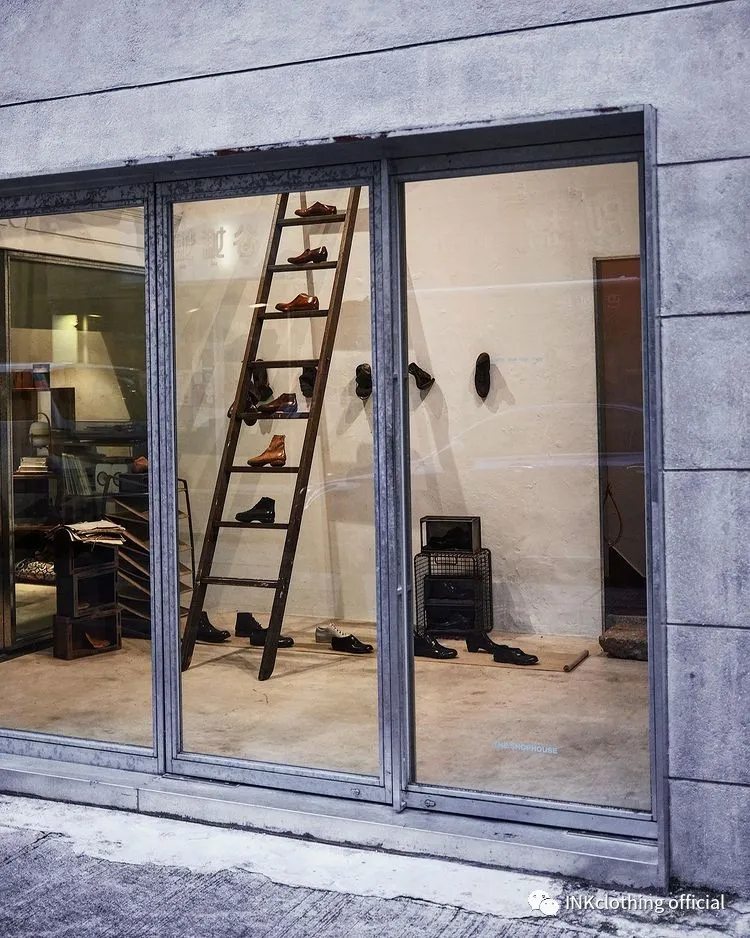 The m_moriabc exhibition seen from the street, shoes on a wooden ladder and on the walls