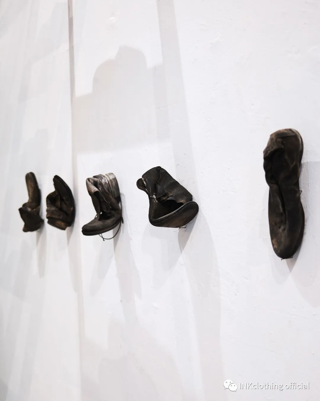 Crushed m_moriabc prototypes mounted on a white wall