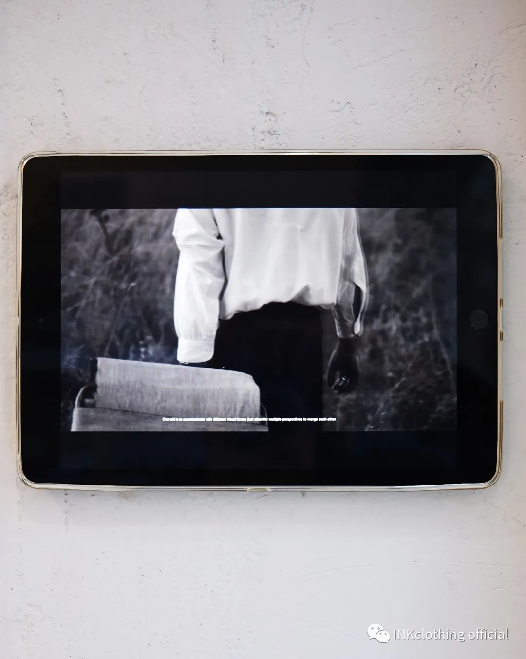 A screen on the gallery wall showing Maurizio Altieri’s documentary film