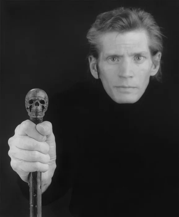 Robert Mapplethorpe, self-portrait holding a cane with a skull handle, 1988